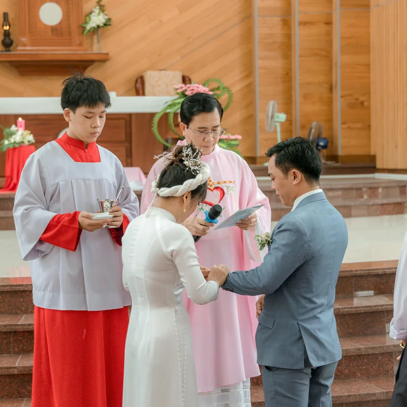 Wedding cake table with three-tiered cake adorned with fresh flowers